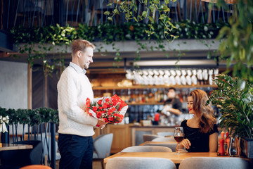 Couple in a restaurant. Lady in a black dress