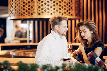 Couple in a restaurant. Lady in a black dress