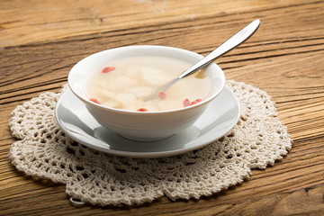 Ginseng has medicinal properties against a white background and can be dipped in water and sliced, also known as American ginseng-Panax quinquefolius