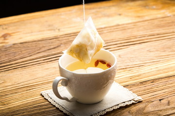 Ginseng has medicinal properties against a white background and can be dipped in water and sliced, also known as American ginseng-Panax quinquefolius