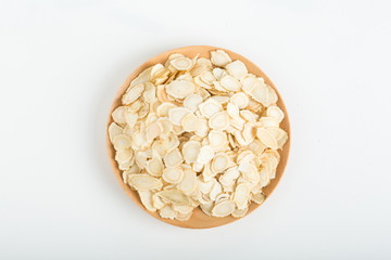 Ginseng has medicinal properties against a white background and can be dipped in water and sliced, also known as American ginseng-Panax quinquefolius