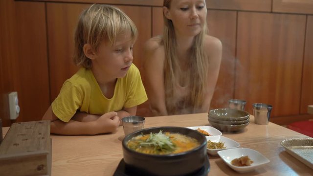 Family enjoy traditional korean food noodle and kimpab in a restaurant