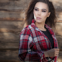 Portrait of beautiful young girl on wooden background.