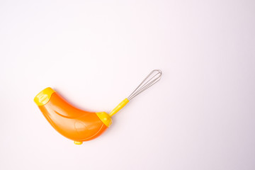 Modern milk frother device orange color in isolated with path