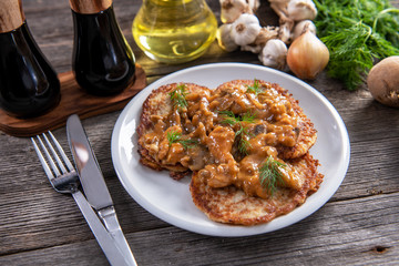 Tasty homemade potato pancakes with meat and mushrooms