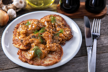 Tasty homemade potato pancakes with meat and mushrooms