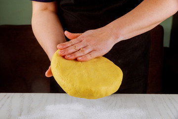 A woman presses on dough for making cookies.