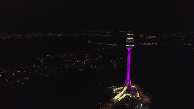 Aerial 4K night shot: camera flying towards Avala TV tower city of Belgrade can be see far behind.