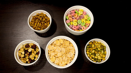 Healthy food. Peanuts, almonds, cereal in a white bowl