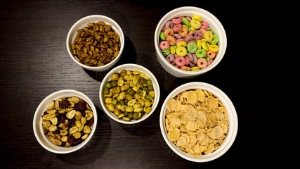 Healthy food. Peanuts, almonds, cereal in a white bowl