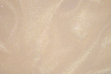 Cream color golden glitter dust bokeh background.