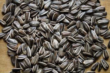 The texture of the seeds. Sunflower seeds laid out on a table.