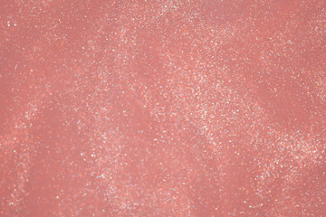 Pink golden glitter dust bokeh background.