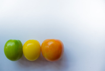 green and yellow and ornamental tomato on a white background.