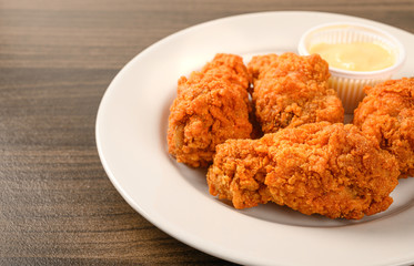 Fried chicken on wood table .