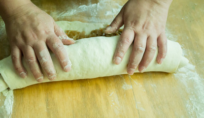 A woman is cooking cabbage roll. Homemade baking. copy space