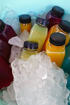 Bottles Of Colorful Cold Pressed Juice On Ice