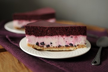 No baked cheesecake with blueberry on white plate. Dark background.