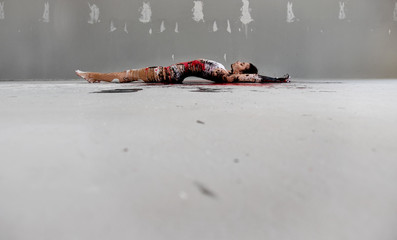 artistically abstract painted young sexy woman in underwear lies on the floor in the artists...
