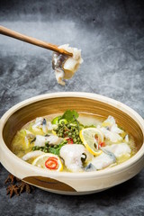 This is a famous dish in chengdu, sichuan province, China. It is called clear sweet sour and hot fish. It is mainly made of lemon, pepper, grass carp, green pepper and chicken soup