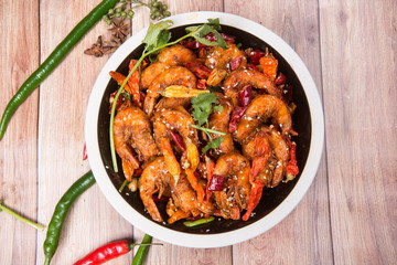 This is an Asian cuisine where you take the shrimp and you fry it, you add the chili, the white sesame, the sichuan peppercorn and then you pour the beer inside
