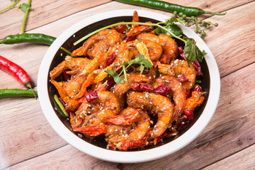 This is an Asian cuisine where you take the shrimp and you fry it, you add the chili, the white sesame, the sichuan peppercorn and then you pour the beer inside