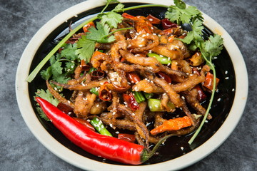 This is a dry pot cooking in Chengdu, Sichuan Province. It's made of octopus tentacles and a variety of chili peppers mixed with beef. Local traditions are only for real men to enjoy.
