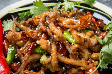This is a dry pot cooking in Chengdu, Sichuan Province. It's made of octopus tentacles and a variety of chili peppers mixed with beef. Local traditions are only for real men to enjoy.