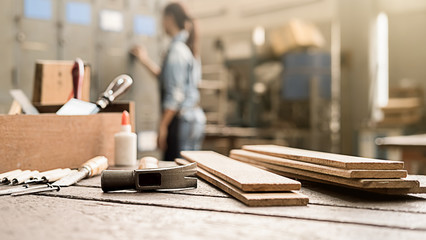 Carpenter working with equipment on wooden table in carpentry shop. woman works in a carpentry shop.