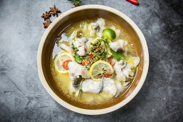 This is a famous dish in chengdu, sichuan province, China. It is called clear sweet sour and hot fish. It is mainly made of lemon, pepper, grass carp, green pepper and chicken soup