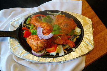 A dish of grilled chicken tandoori at an Indian restaurant