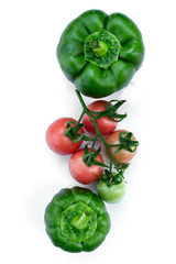 Green bell pepper and tomatoes isolated on a white background.