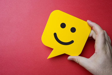 Customer service experience and business satisfaction survey. Man holding yellow speech bubble with...