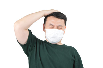 Asian man feeling unwell and headache, wearing protective mask against transmissible infectious disease, virus, bacteria, allergy, flu, dust, air pollution. Health care and environment concept. 
