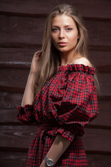 Naklejka premium Portrait of beautiful young girl on wooden background.