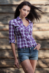 Fototapeta premium Portrait of beautiful young girl on wooden background.