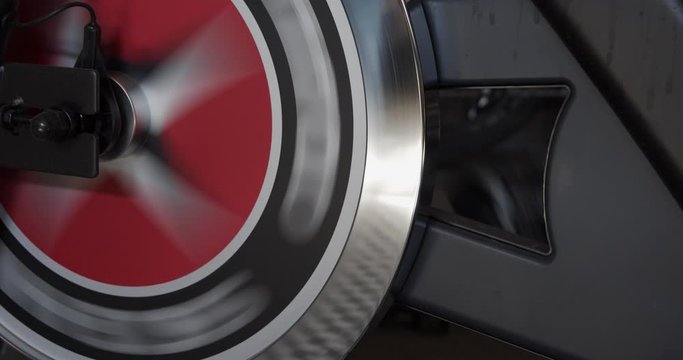 Close up fly wheel on spin bike with sweat marks.