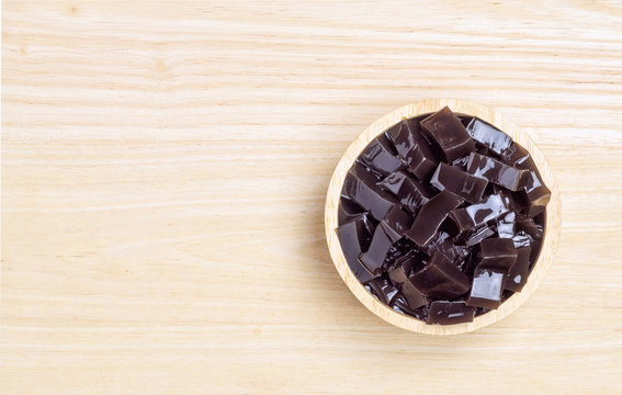 Grass jelly  (Mesona chinensis) or leaf jelly or herb jelly is a jelly-like dessert in East Asia and Southeast Asia. Created by using the Platostoma palustre plant. top view with copy space.