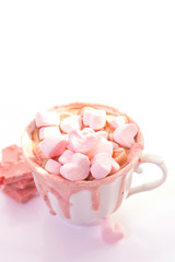 Obraz na płótnie Canvas strawberry pink color hot chocolate with heart shaped marshmallows 