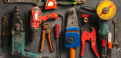 Construction worker tools on a dark background top view. Remodel concept
