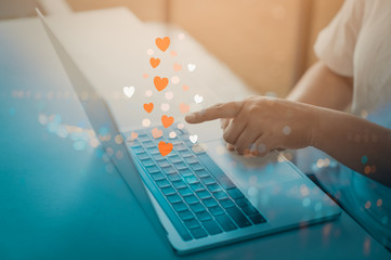 Woman hands using laptop computer with social love website for valentine's day.