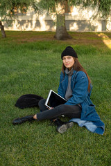 a young girl freelancer illustrator is holding a tablet on which she draws