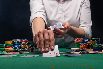 Girl dealer, croupier hands out poker cards in a casino, concept for business games, casino