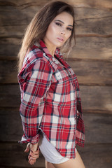 Fototapeta premium Portrait of beautiful young girl on wooden background.