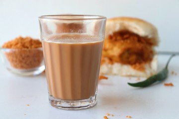 Vada pav or wada pao is a vegetarian fast food dish native to the state of Maharashtra. Famous Mumbai street food served with Red chutney and fried green chili. Copy space