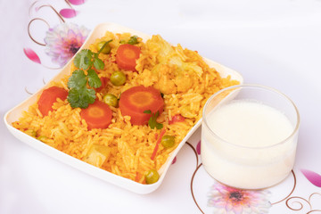 Basmati rice vegetable pulao served in plate with curd