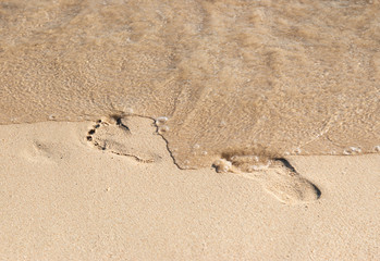 footprints in the sand by the sea