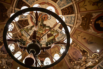 Retro Chandelier Hanging off Vintage Ceiling in a Luxury Hotel