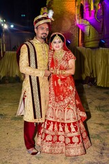 A Young Couple Posing With Traditional Outfit In Indian Wedding.