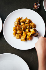 Top Down View of Agnolotti Served on a Round Plate 